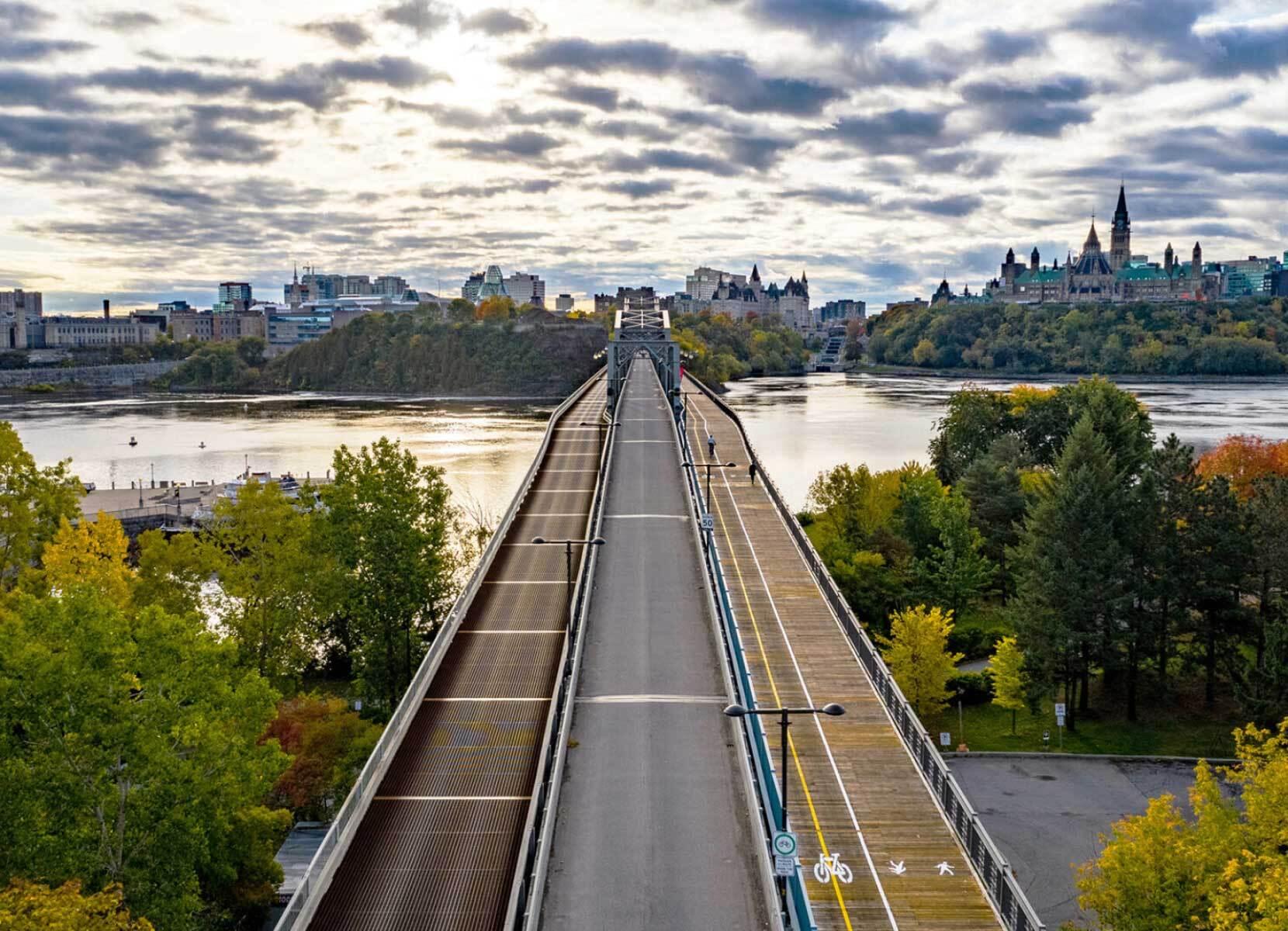 View from one side of a river to the other over a bridge with separated traffic, pedestrian and cycle lanes