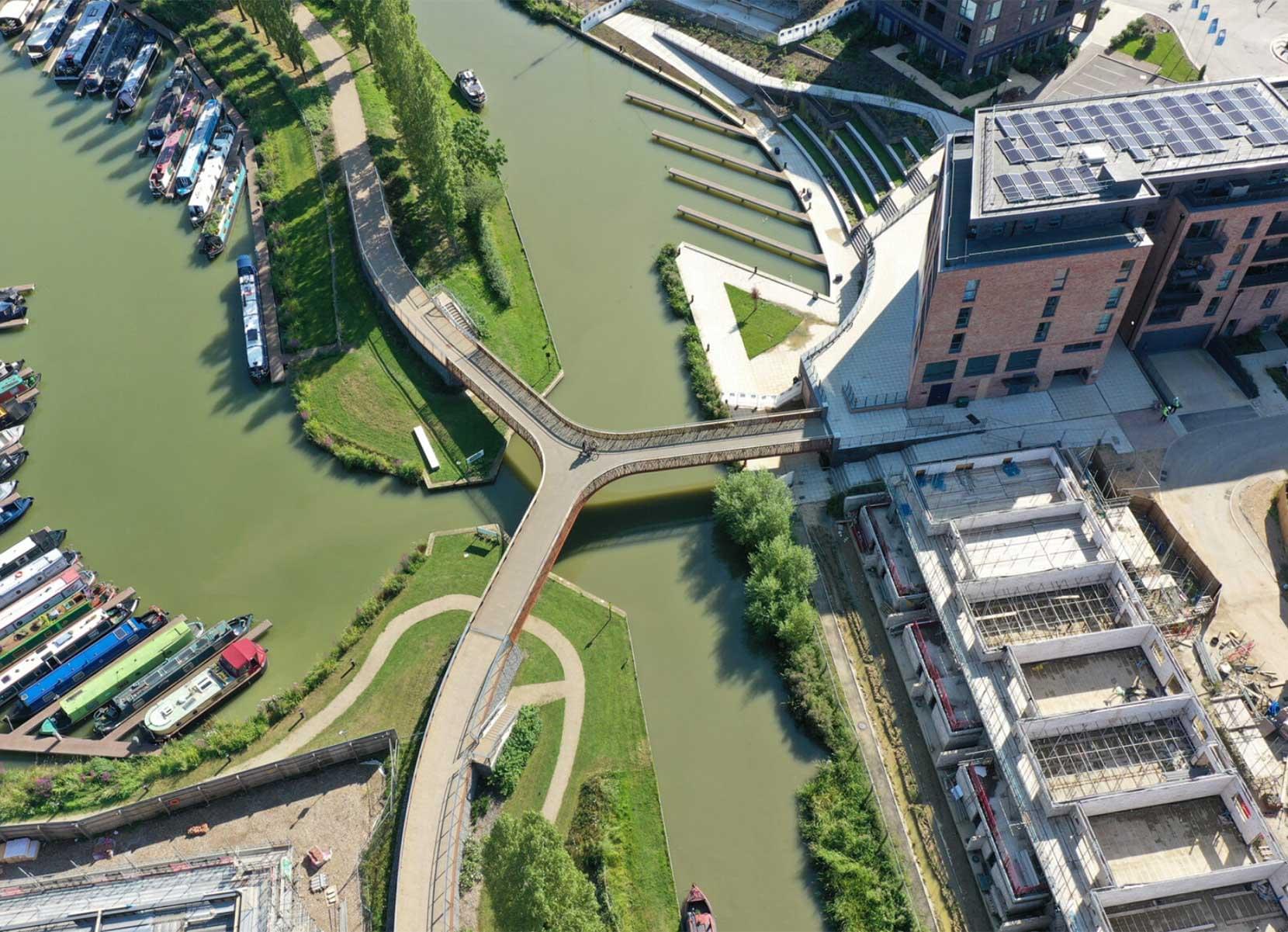 A "Y" shaped footbridge joins up a towpath broken by a marina entrance and also allows crossings to the new development on the other side of the canal.