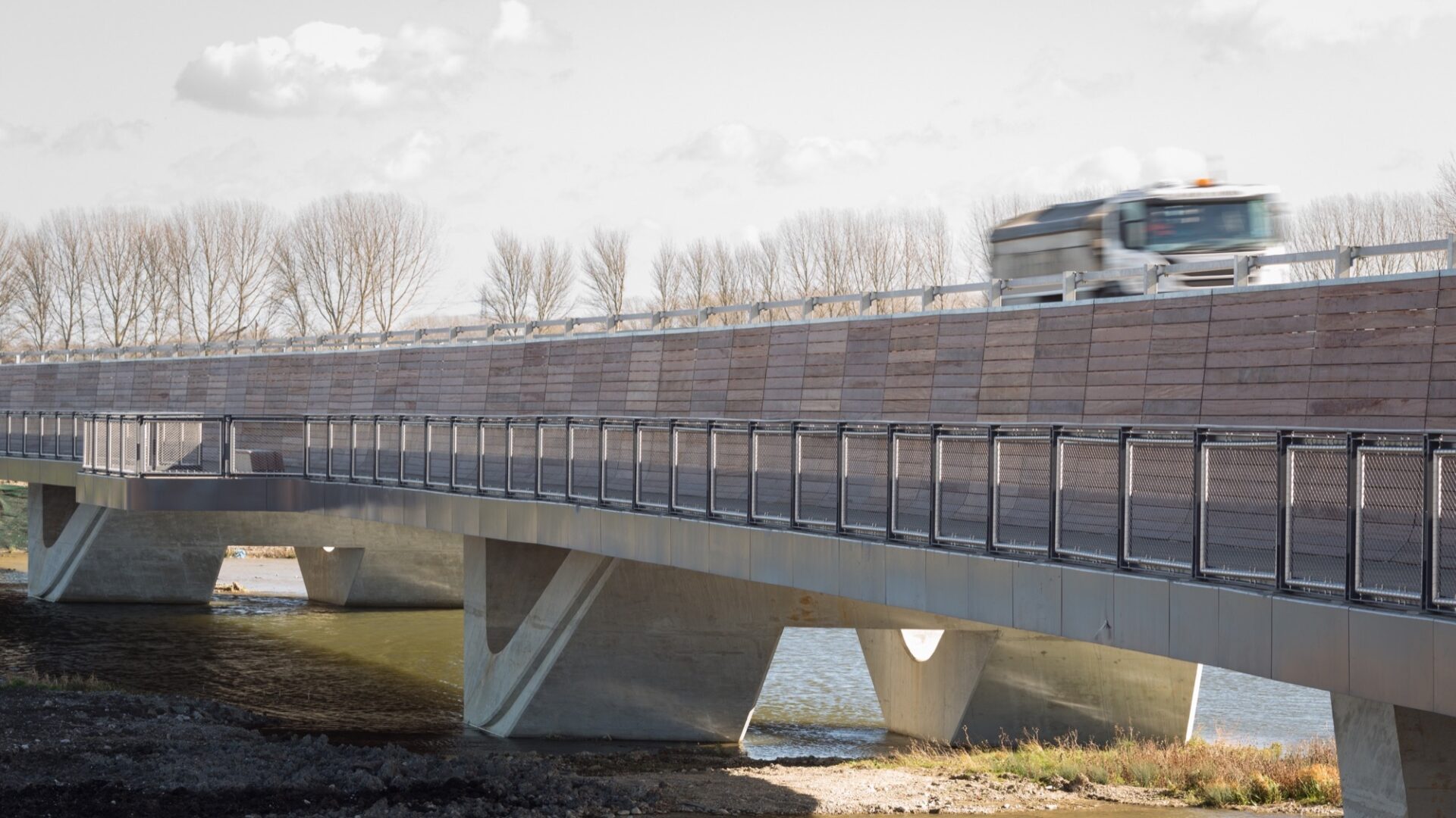 Lorry travelling at speed along road above walkway on Ely Bypass
