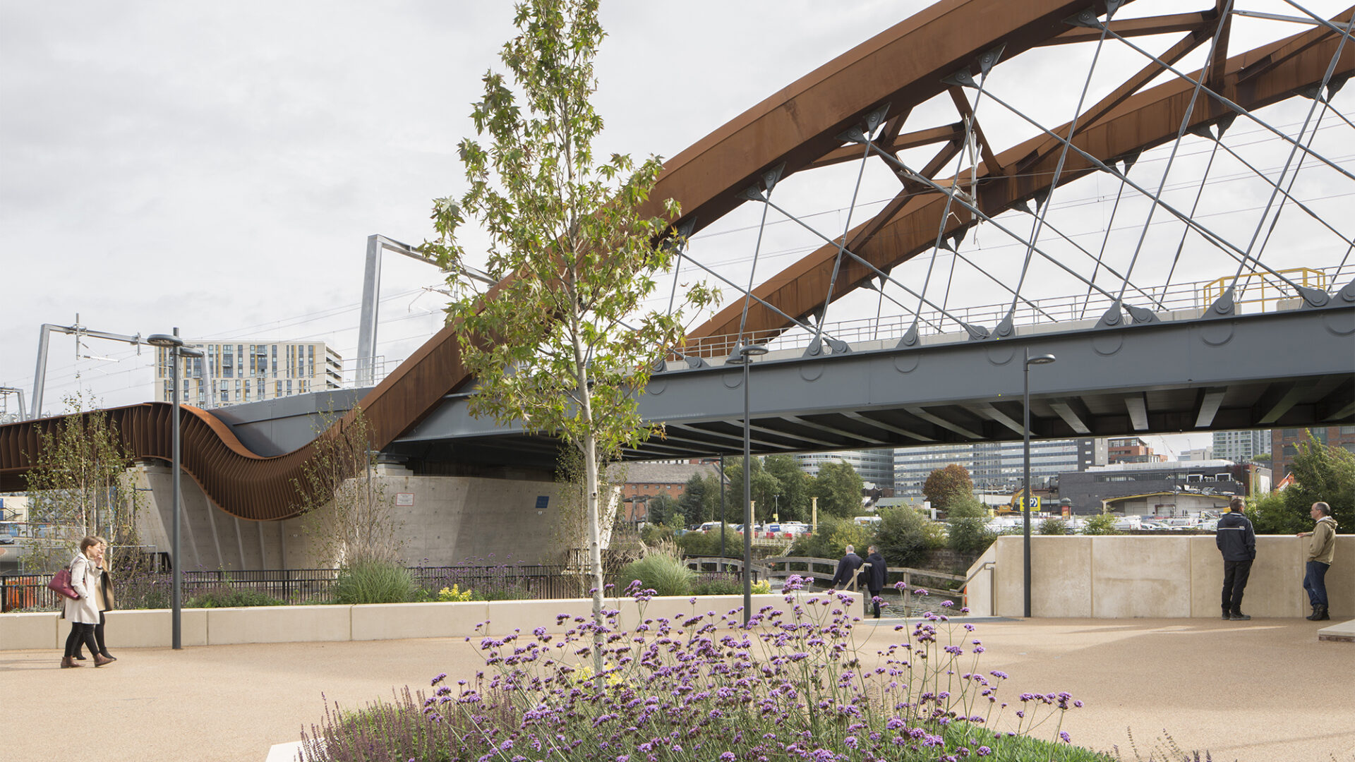 View of rail bridge from pedestrianised area alongside the bridge