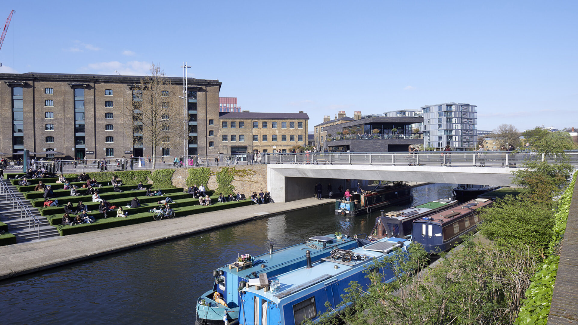 Grass steps and canal boats at Regents Canal bridge, Kings Cross