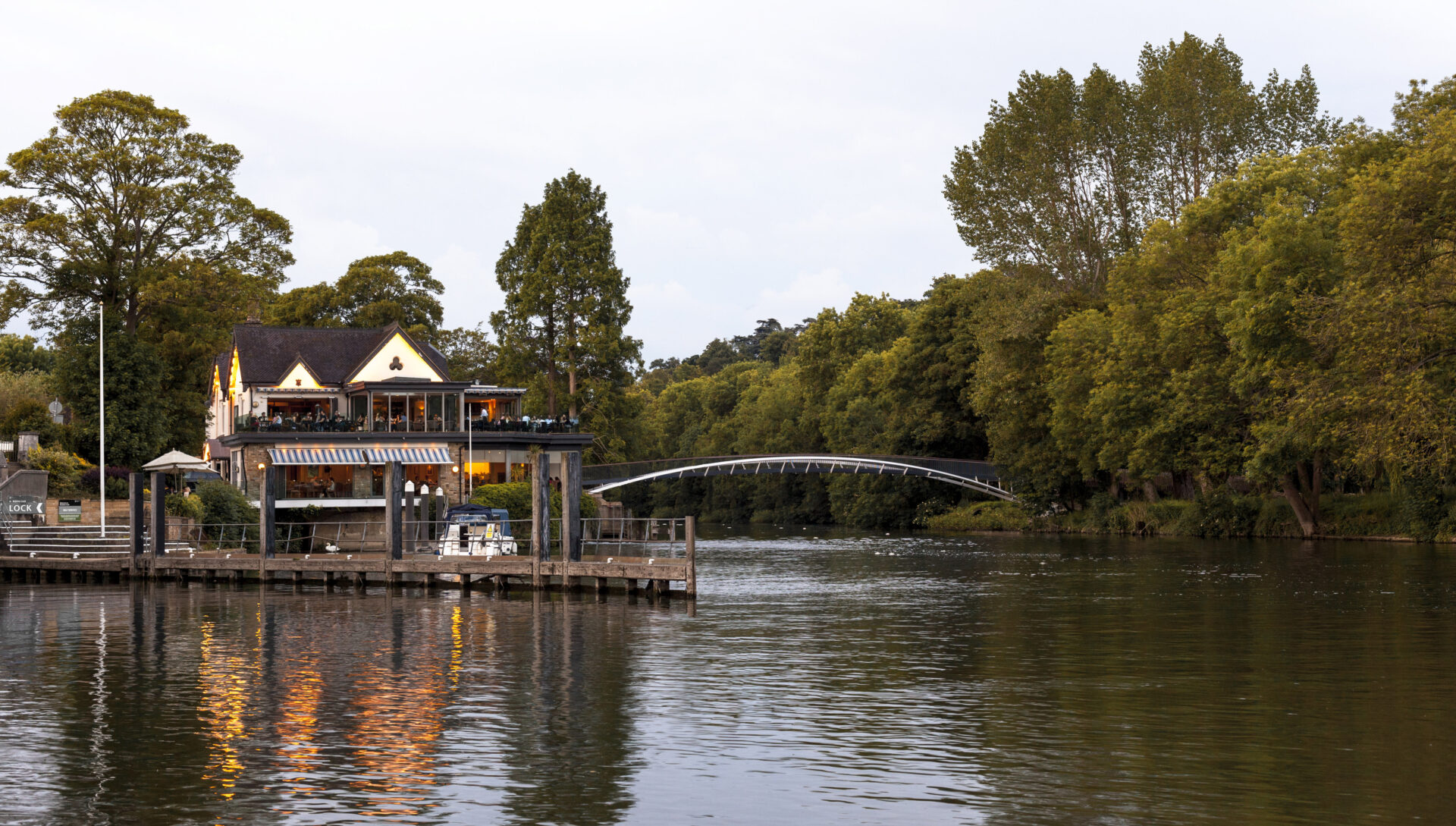 Early evening view down river looking West at the footbridge with Boulters Restaurant to the left