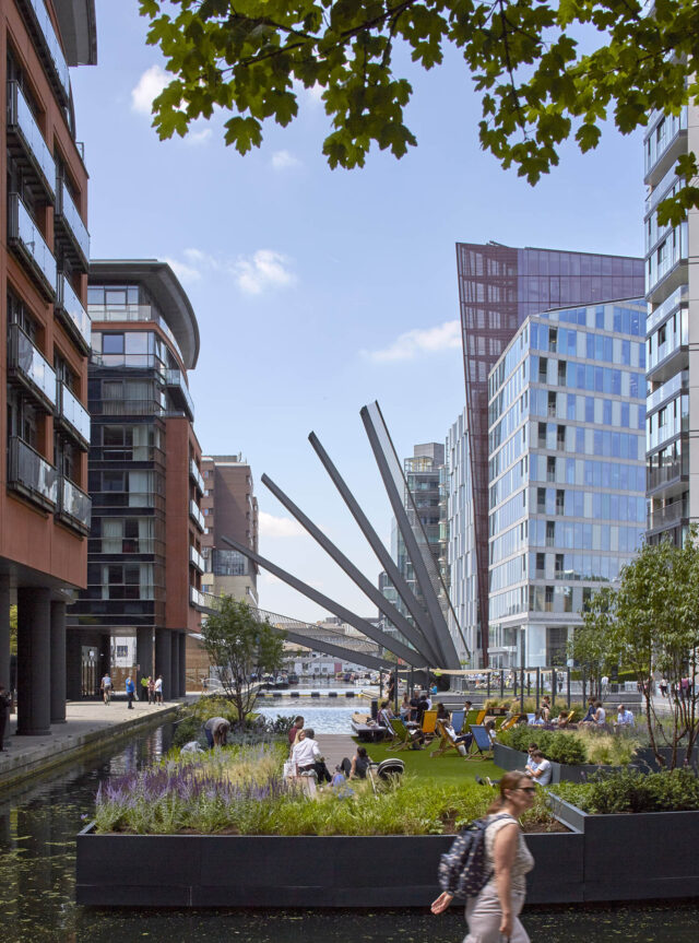 People walking around Merchant Square with the fan bridge in the background