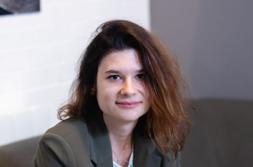 A brown haired woman in a business suit