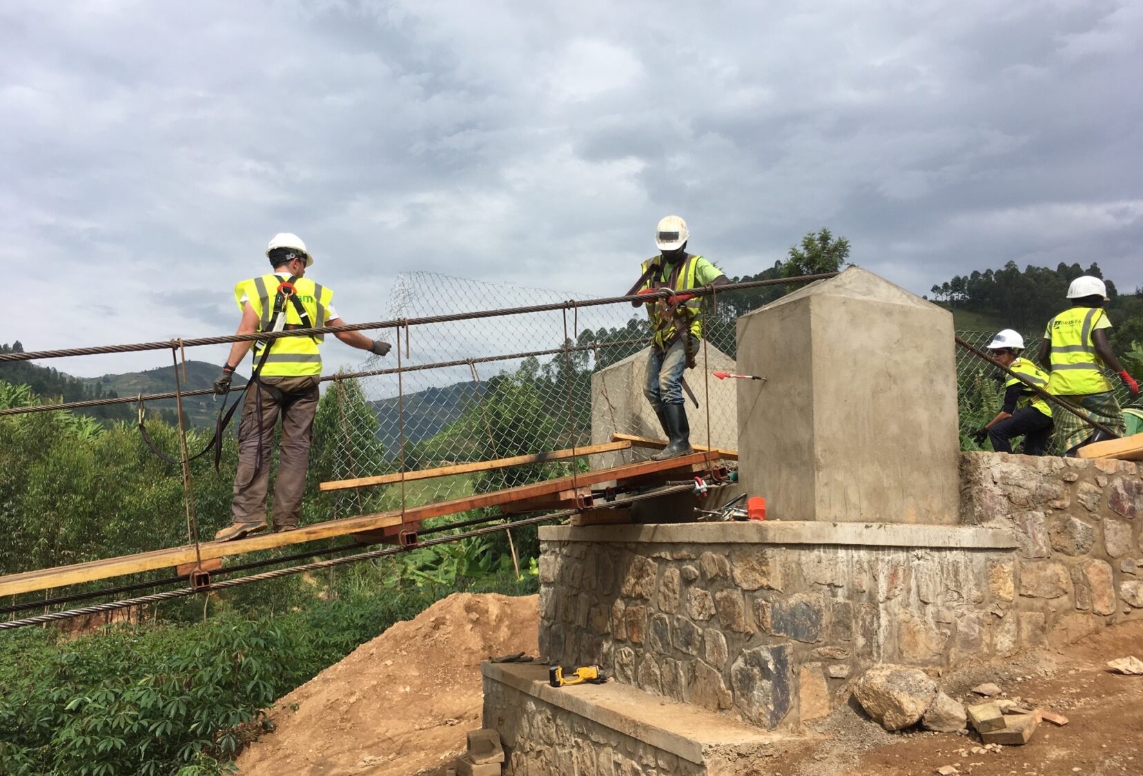 Workers in high visibility vests constructing bridge