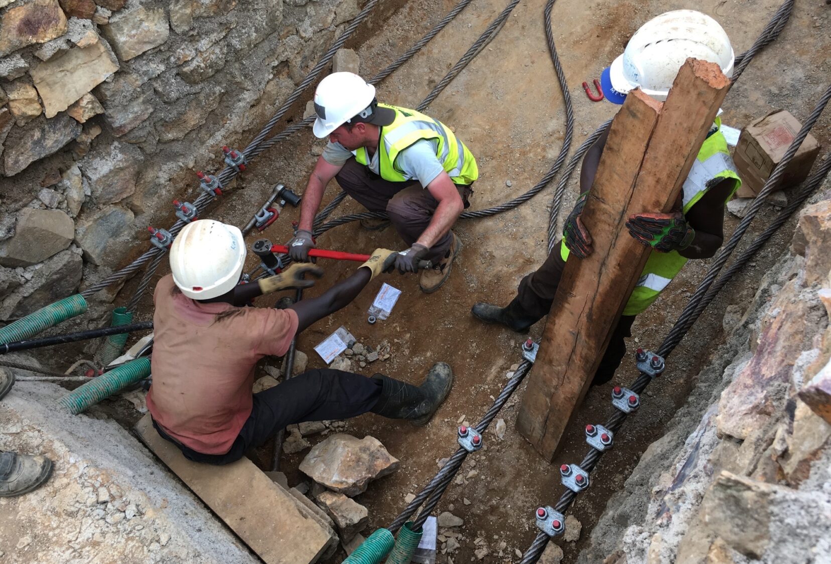 Workers arranging and securing the suspension cables