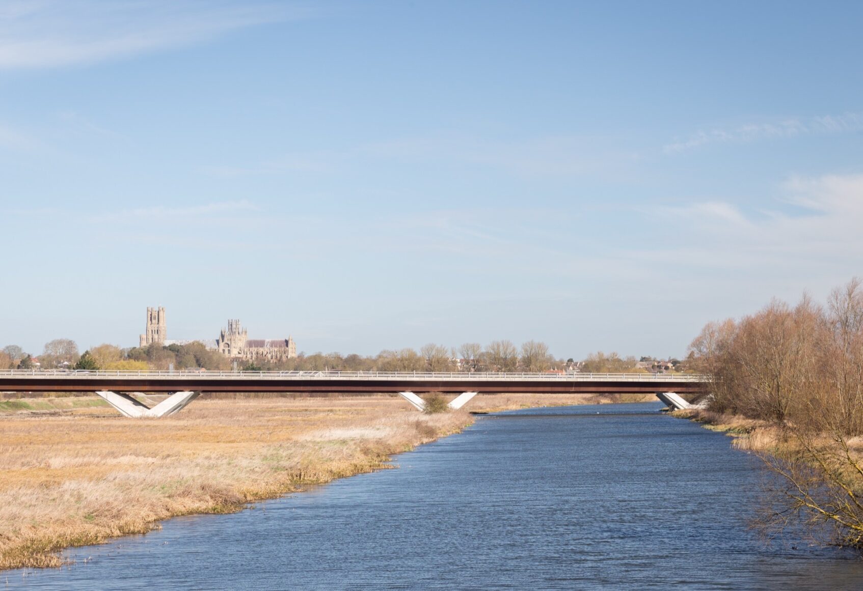 Down river view looking at Ely bypass with Ely Cathedral in the distant behind it