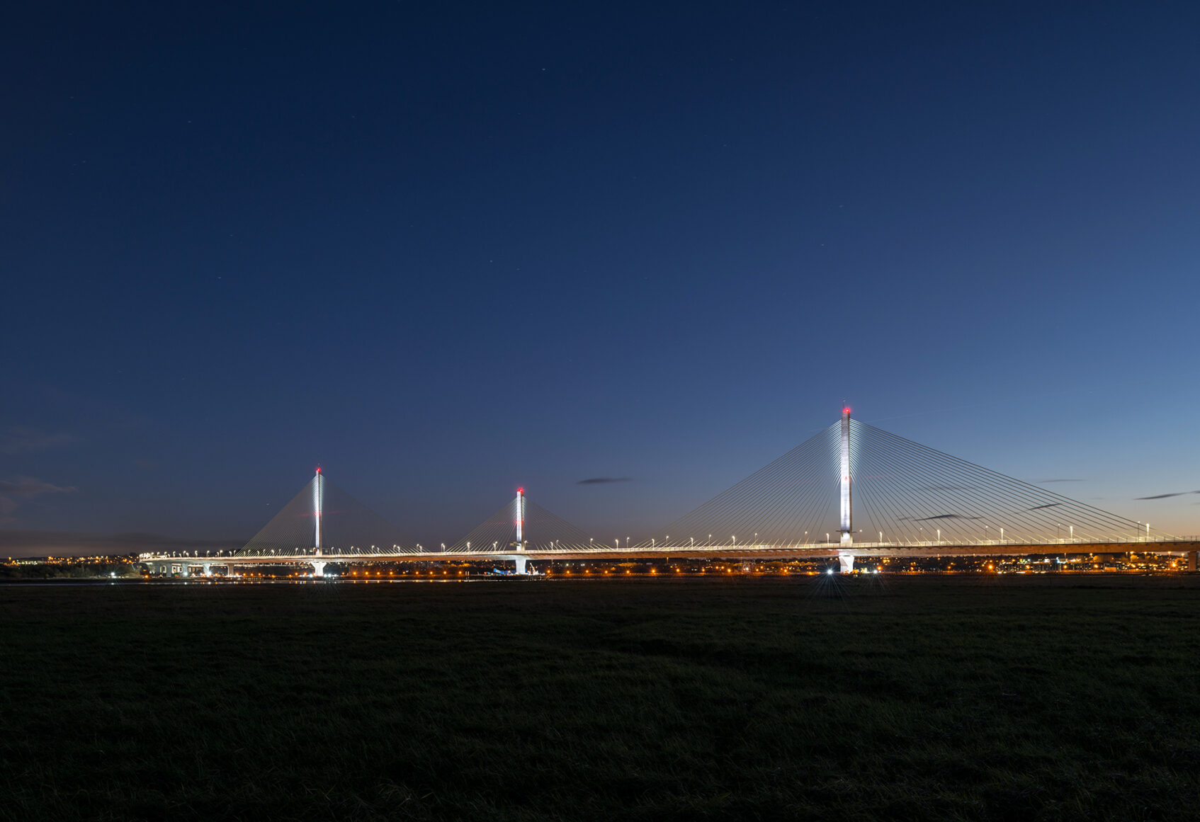 Distant night view of road bridge lit up