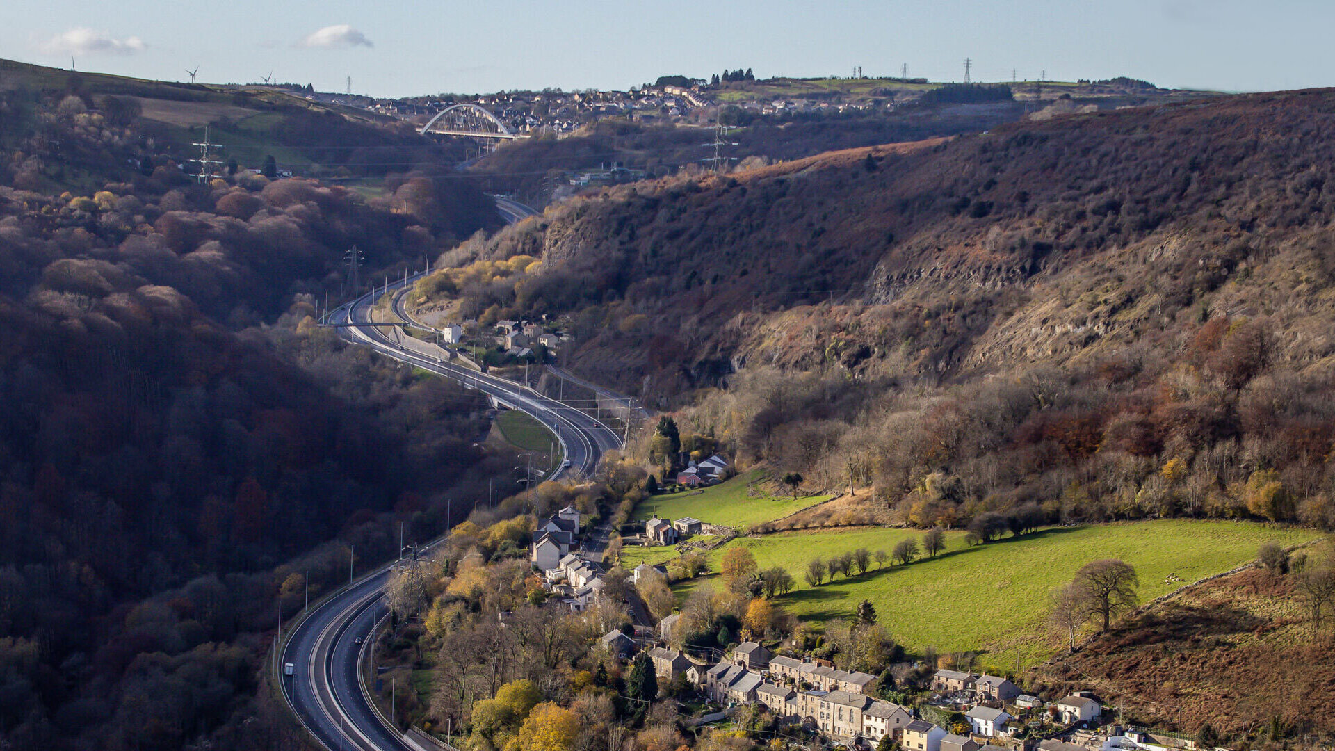 Example of a typical transport corridor: a winding dual carriageway with a road bridge in the distance
