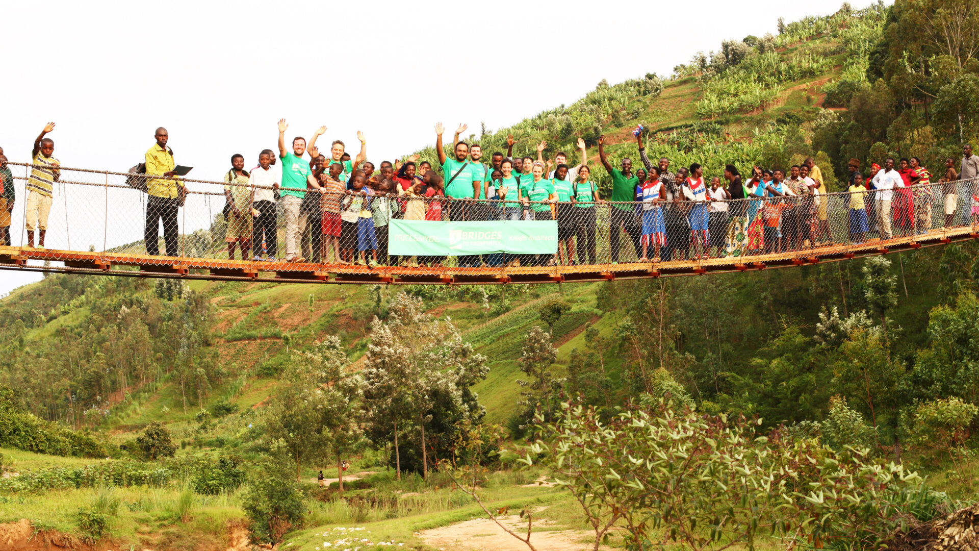 The local community and builders on the completed bridge