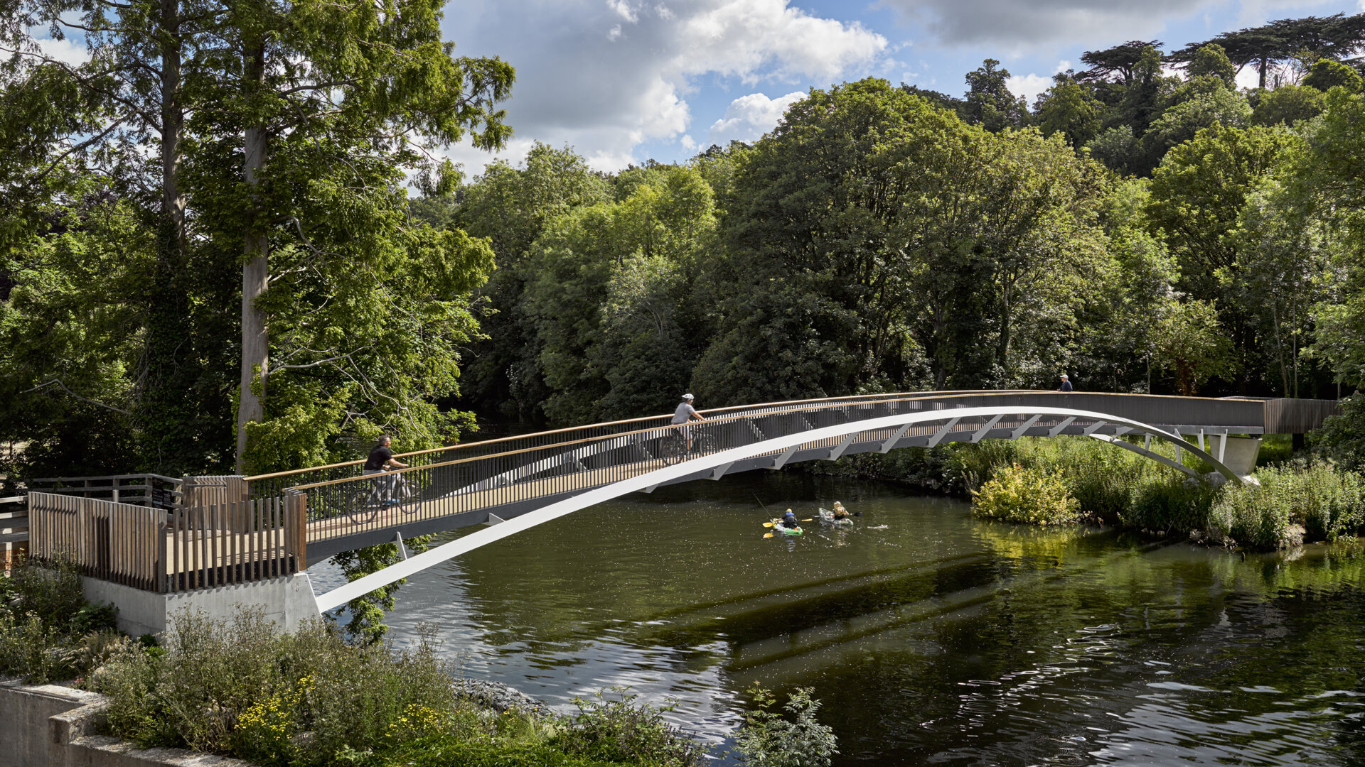Taplow footbridge looking East with kayaks on the river and pedestrians on the bridge